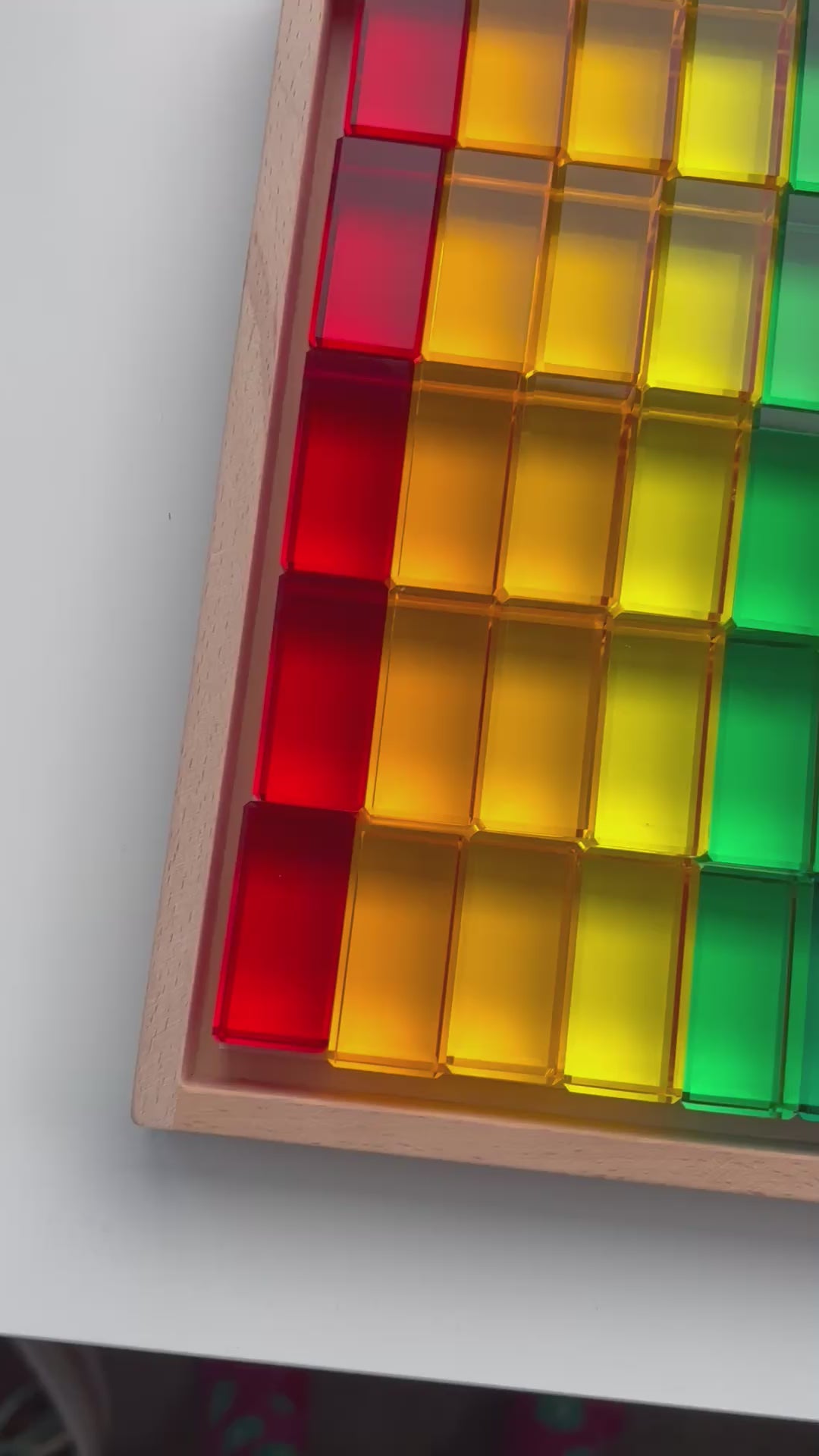 A video of the Infinite Wonder Rectangle Rainbow Building Blocks in a wooden tray demonstrating how beautiful the colours are and how clear the translucent acrylic material is.