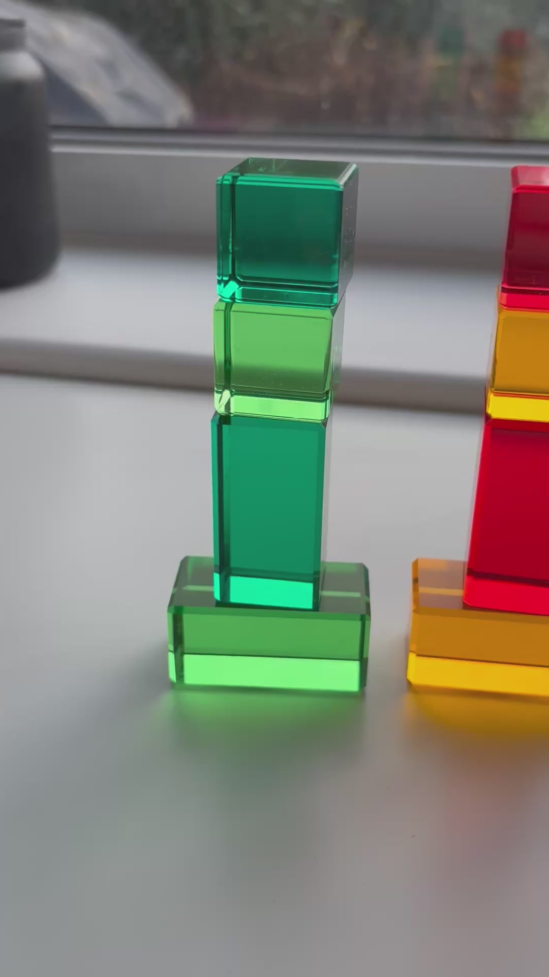 A video of the Infinite Wonder Rectangle and Cube Rainbow Building Blocks demonstrating how the light refracts through the translucent acrylic material and reflects the colour on to the surface below.